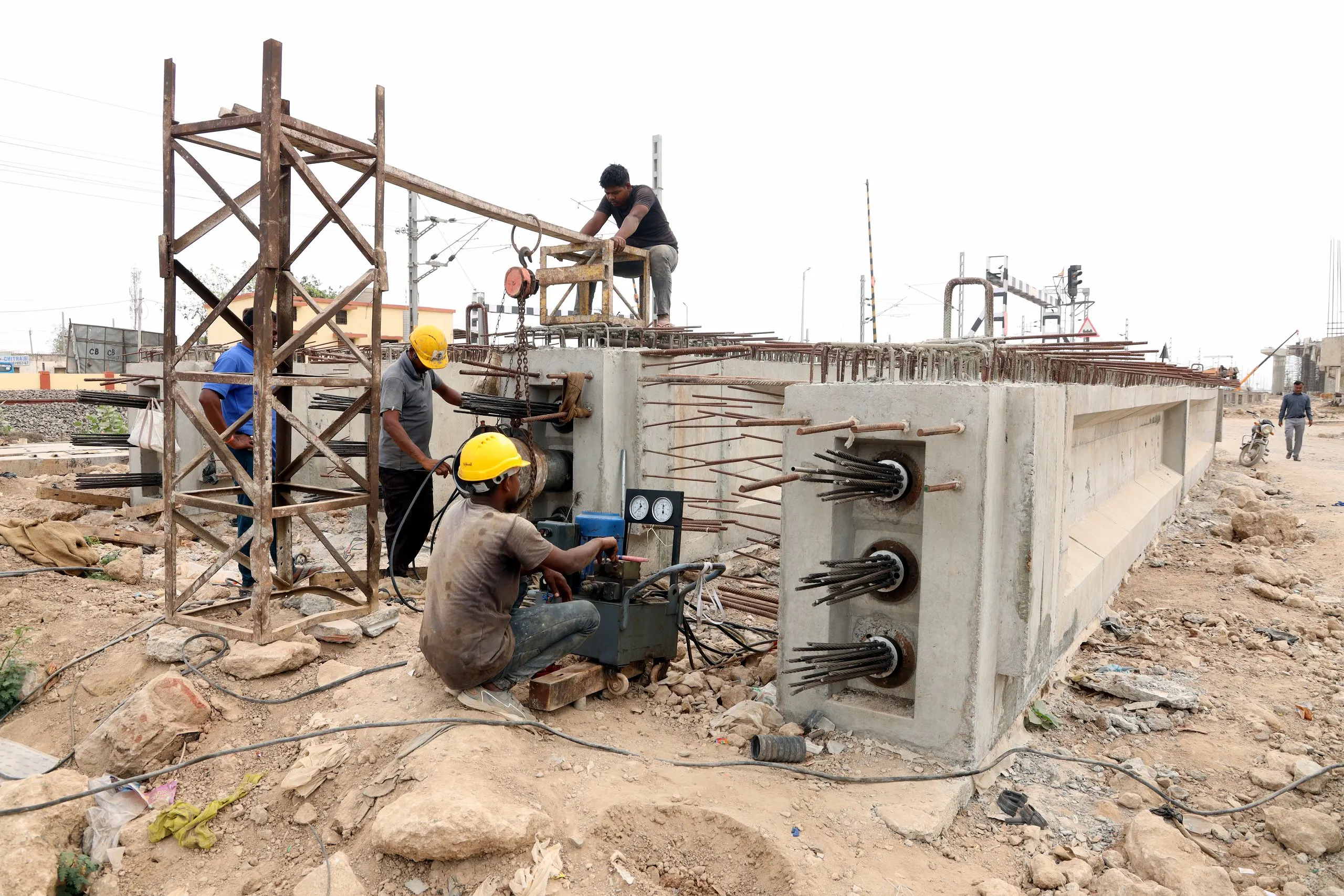 Stressed tendons on a girder end block at the Okha railway bridge, Gujarat, with the TYROS crew at the power pack